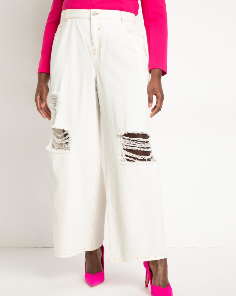 Front of a model wearing a size 26 Wide Leg Distressed Jeans- White in White by ELOQUII. | dia_product_style_image_id:271043